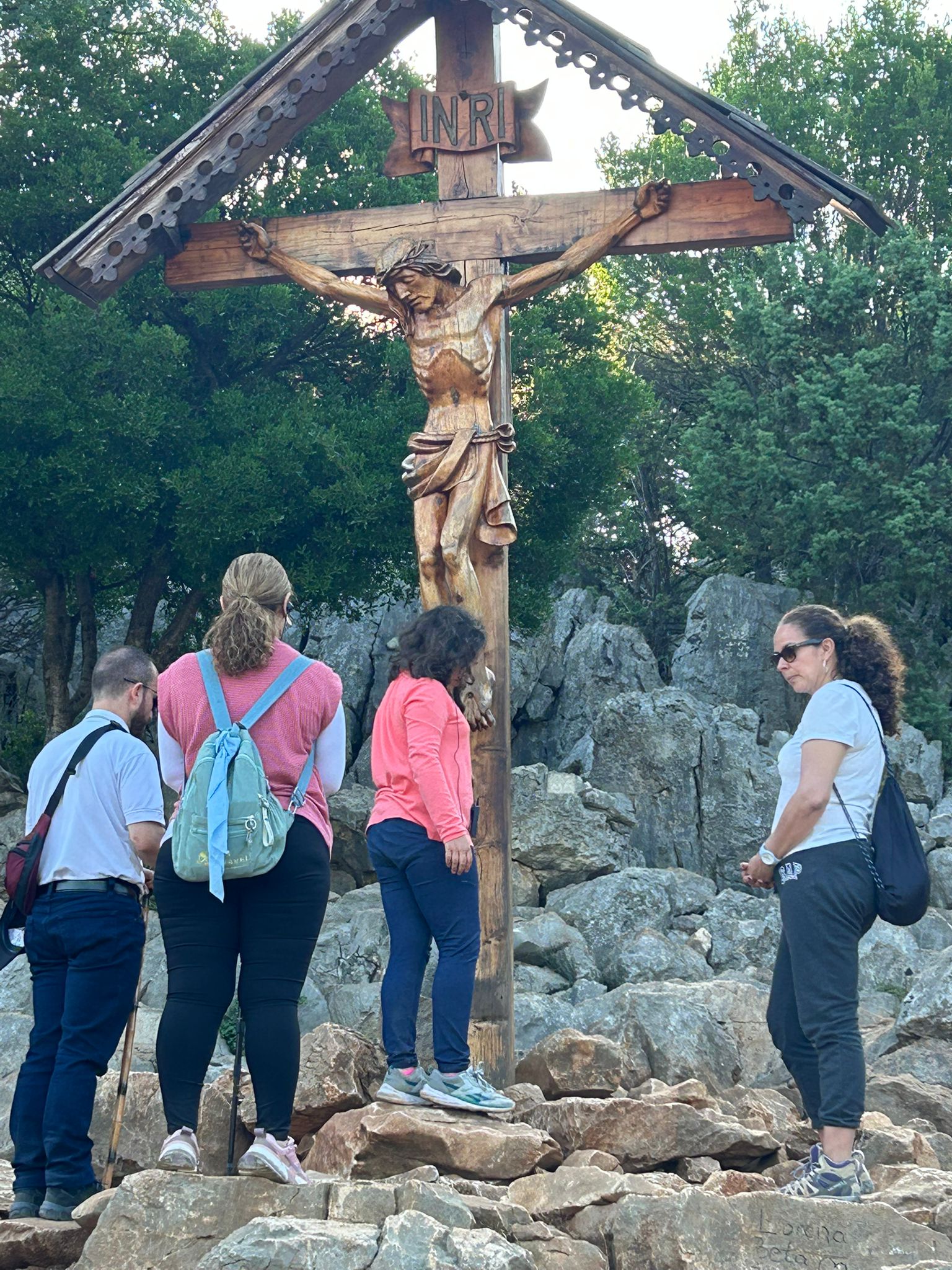 Final blessing ceremony with priest and pilgrims in sacred sanctuary