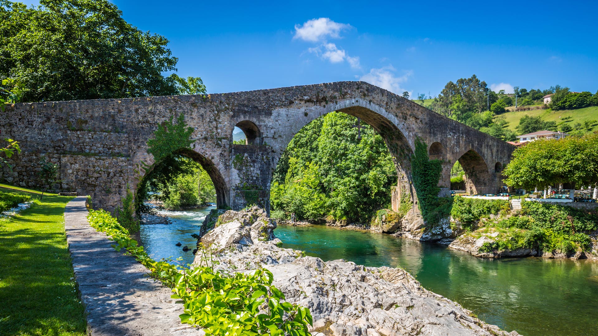 Medieval bridge of Cangas de Onís, symbol of Asturias and gateway to the Picos de Europa, topped by the iconic Victory Cross.