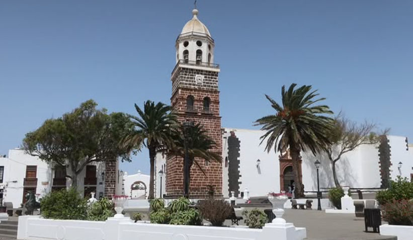 Church bell tower with palm trees in Nazareth town square