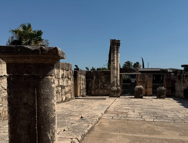 Ancient synagogue ruins with white stone columns in Capernaum