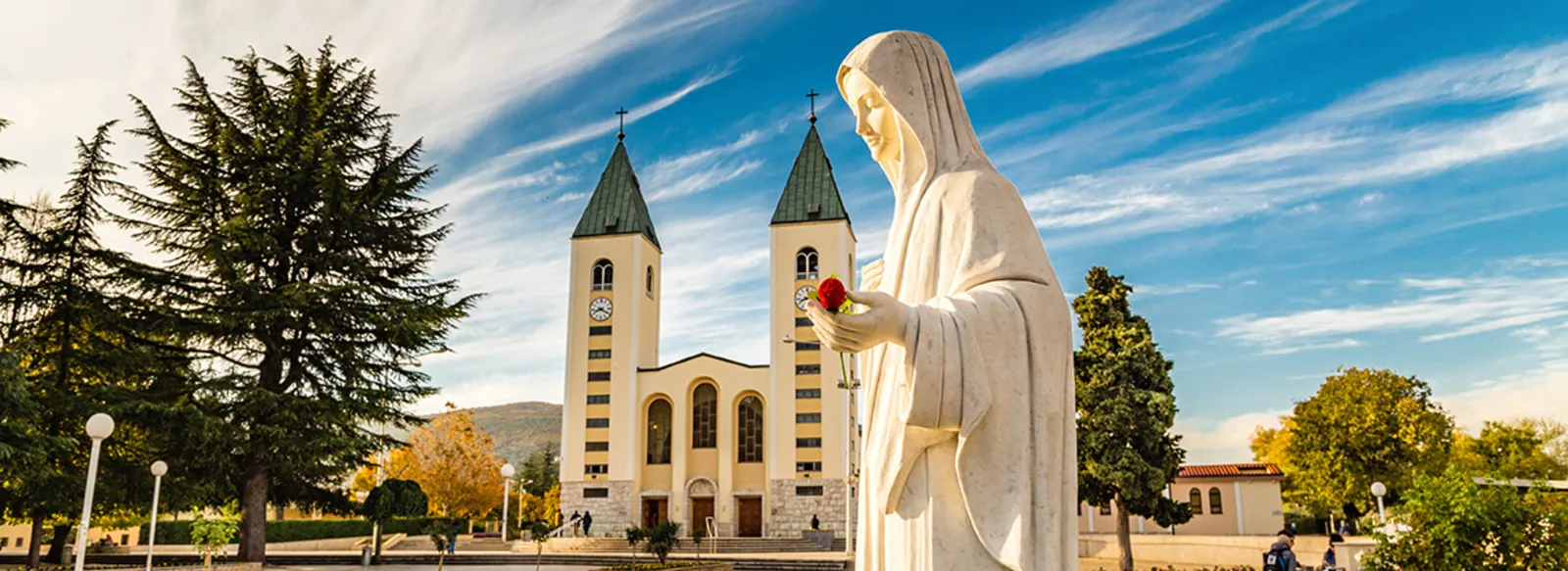 Virgin Mary statue in Medjugorje at sunset