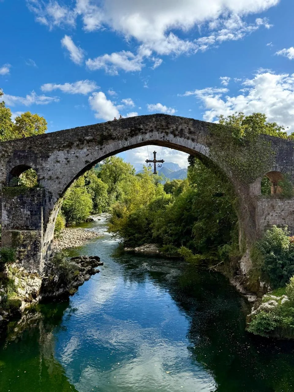 Bridge of Cangas de Onís: Beneath the Victory Cross, history is reflected in the river.